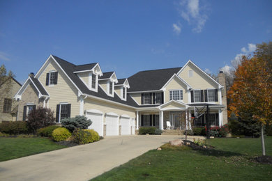 Inspiration for a large beige two-story vinyl exterior home remodel in Indianapolis