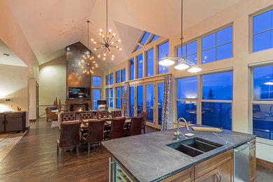 Inspiration for a mid-sized contemporary medium tone wood floor great room remodel in Indianapolis with white walls, a two-sided fireplace and a stone fireplace