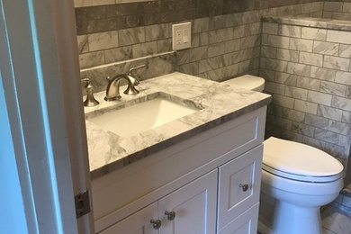 Inspiration for a small modern 3/4 gray tile and marble tile marble floor and gray floor bathroom remodel in New York with shaker cabinets, white cabinets, a one-piece toilet, white walls, an undermount sink, marble countertops and gray countertops