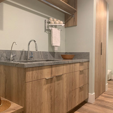 HIDDEN STACKED WASHER & DRYER. MONOCHROMATIC TONES W/COORDINATED FLOOR & CABS
