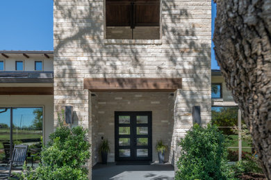 Huge transitional gray two-story stone house exterior photo in Other