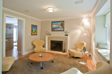 Small minimalist enclosed medium tone wood floor living room photo in New York with gray walls, a standard fireplace and a stone fireplace