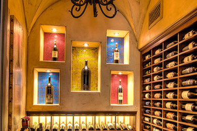 Large tuscan medium tone wood floor wine cellar photo in Dallas
