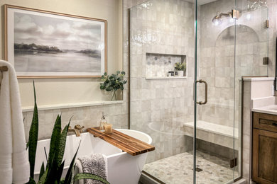 Example of a mid-sized transitional master multicolored tile and porcelain tile porcelain tile, black floor and double-sink bathroom design in Milwaukee with recessed-panel cabinets, medium tone wood cabinets, a two-piece toilet, beige walls, an undermount sink, quartz countertops, a hinged shower door, white countertops and a built-in vanity