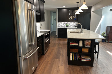 Kitchen - mid-sized transitional kitchen idea in Other with an undermount sink, shaker cabinets, black cabinets, quartz countertops, multicolored backsplash, mosaic tile backsplash, stainless steel appliances and white countertops