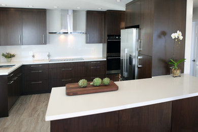 Mid-sized contemporary separate kitchen in Vancouver with an undermount sink, flat-panel cabinets, dark wood cabinets, quartz benchtops, white splashback, stainless steel appliances and with island.
