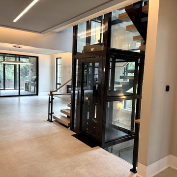 Project #136 | Modern Floating Staircase Encircling Glass Elevator