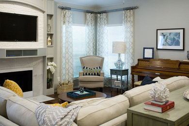Inspiration for a mid-sized transitional open concept medium tone wood floor and brown floor family room remodel in Dallas with gray walls, a standard fireplace, a tile fireplace and a wall-mounted tv