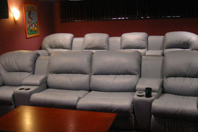 Inspiration for a mid-sized enclosed carpeted home theater remodel in Portland with red walls and a projector screen