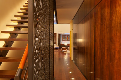 Hallway - contemporary dark wood floor hallway idea in New York