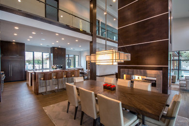 This is an example of a large contemporary kitchen/dining combo in Orange County with ceramic floors, grey walls and brown floor.