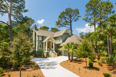 Example of a mid-sized transitional green two-story concrete house exterior design in Charleston