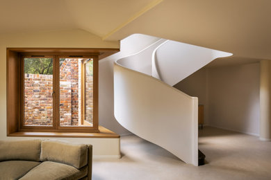 This is an example of a wood curved metal railing staircase in London.