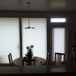 Duette honeycomb shades in a small dining area facing West - Cellular Shades