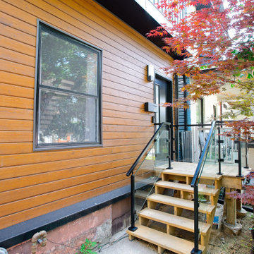 Natural Wood Facade with Black Door and Glass Entry Railing | East York