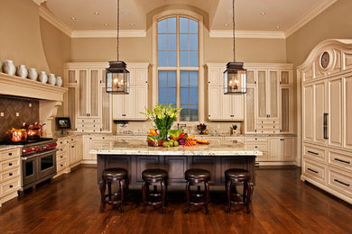 Huge tuscan u-shaped dark wood floor and brown floor eat-in kitchen photo in Other with an undermount sink, raised-panel cabinets, white cabinets, granite countertops, paneled appliances and an island