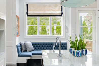 Mid-sized transitional eat-in kitchen photo in New York with an undermount sink, raised-panel cabinets, white cabinets, marble countertops and an island