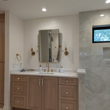 Amish Frameless White oak primary bath and closet with painted vanity