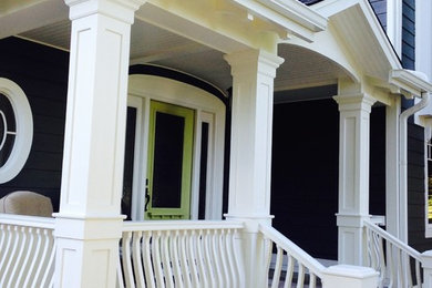 Arts and crafts brick front porch photo in Toronto with a roof extension