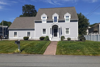 Example of a classic gray two-story vinyl exterior home design in Providence with a shingle roof