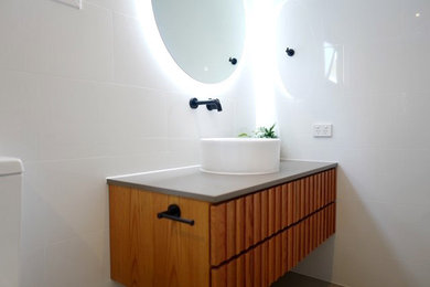 Inspiration for a bathroom in Brisbane with medium wood cabinets, a vessel sink and a floating vanity.