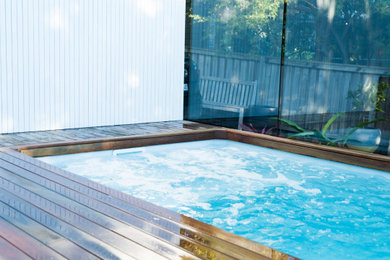 Small modern backyard rectangular pool in Sydney with with a pool and decking.
