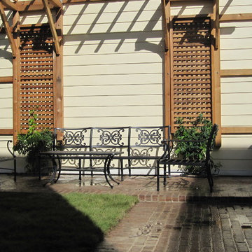 Two paths leading to patio with Pergola.