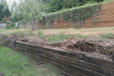 Retaining wall remodel with slope regrade and mulch install