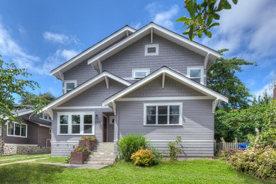 Example of a large trendy gray three-story concrete fiberboard exterior home design in Seattle with a shingle roof