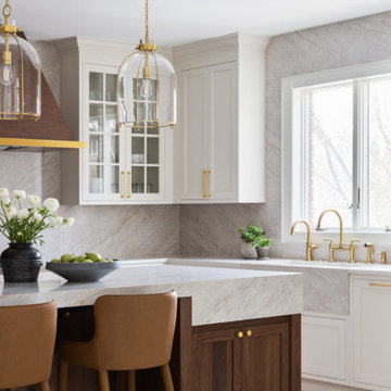 Custom Walnut and White Kitchen Remodel with Marble Slab Backsplash and Brass Ac