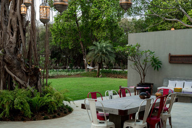 Photo of a large eclectic backyard patio in Mumbai.