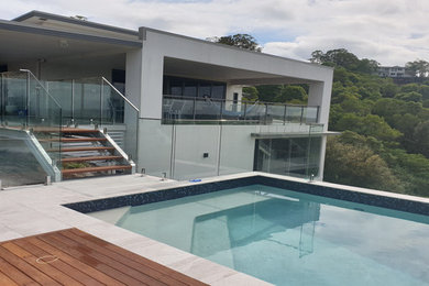Inspiration for a mid-sized contemporary front yard rectangular aboveground pool in Sunshine Coast with decking.
