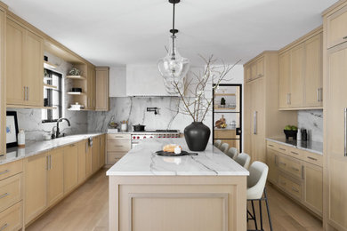 Example of a large transitional u-shaped light wood floor eat-in kitchen design in Chicago with shaker cabinets, light wood cabinets, quartzite countertops, gray backsplash, stone slab backsplash, paneled appliances, an island and gray countertops
