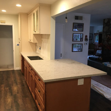 Antique white kitchen upper cabinet with cinnamon cabinets and Quartz countertop