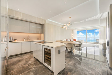 Inspiration for a large transitional porcelain tile, gray floor, tray ceiling and wallpaper dining room remodel in Miami with beige walls