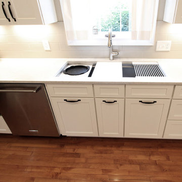 White Kitchen with Quartz Countertop, Galley Workstation and Large Subway Tile
