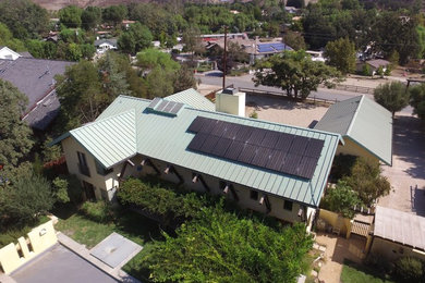 Example of a mid-sized southwest two-story house exterior design in Los Angeles with a metal roof