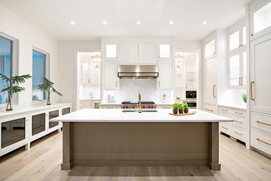 Kitchen - large transitional u-shaped light wood floor and beige floor kitchen idea in Other with an undermount sink, beaded inset cabinets, white cabinets, quartzite countertops, white backsplash, stone slab backsplash, paneled appliances, an island and white countertops