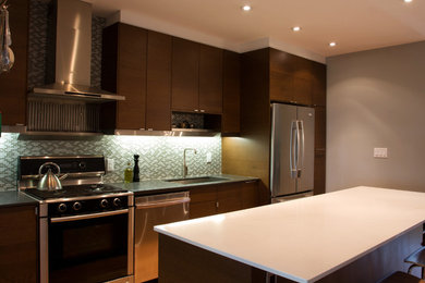 Inspiration for a mid-sized contemporary single-wall medium tone wood floor eat-in kitchen remodel in Toronto with an undermount sink, flat-panel cabinets, medium tone wood cabinets, quartzite countertops, blue backsplash, mosaic tile backsplash, stainless steel appliances and an island