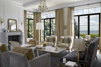Large trendy formal and enclosed light wood floor and brown floor living room photo in New York with white walls, a standard fireplace, a wood fireplace surround and no tv