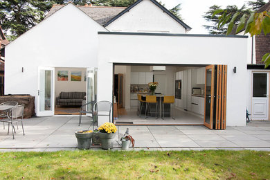 Photo of a medium sized and white contemporary two floor render and rear detached house in Berkshire with a hip roof.