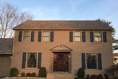 Inspiration for a mid-sized timeless beige two-story vinyl exterior home remodel in Philadelphia with a shingle roof