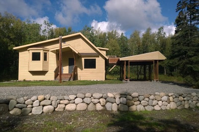 Inspiration for a small timeless yellow one-story wood exterior home remodel in Other