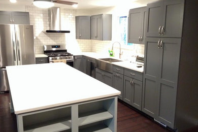 Mid-sized trendy u-shaped dark wood floor eat-in kitchen photo in Seattle with a farmhouse sink, shaker cabinets, gray cabinets, granite countertops, white backsplash, subway tile backsplash, stainless steel appliances and an island