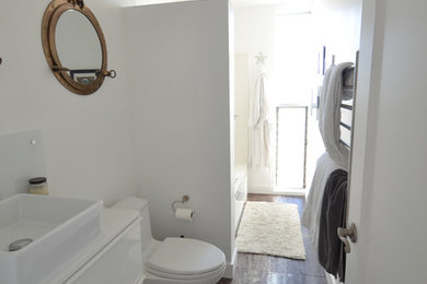 Mid-sized beach style 3/4 black tile and porcelain tile bathroom photo in San Diego with flat-panel cabinets, white cabinets, a one-piece toilet, white walls and quartz countertops