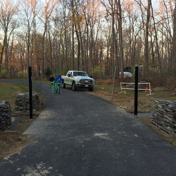 Estate gate with natural stone pillars