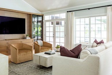 Mid-sized trendy formal and open concept medium tone wood floor and vaulted ceiling living room photo in Los Angeles with no fireplace and a wall-mounted tv