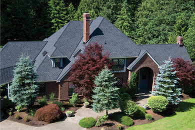 Exterior home photo in Seattle with a shingle roof and a black roof
