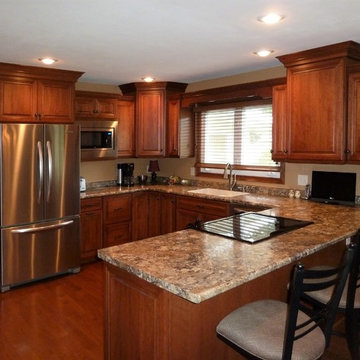 Omega Cabinetry. Destin door, Cherry wood, Nutmeg stain.