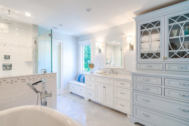 Example of a large eclectic master white tile and marble tile marble floor, white floor, single-sink and wainscoting bathroom design in Philadelphia with beaded inset cabinets, blue cabinets, a one-piece toilet, blue walls, an undermount sink, marble countertops, a hinged shower door, white countertops and a freestanding vanity